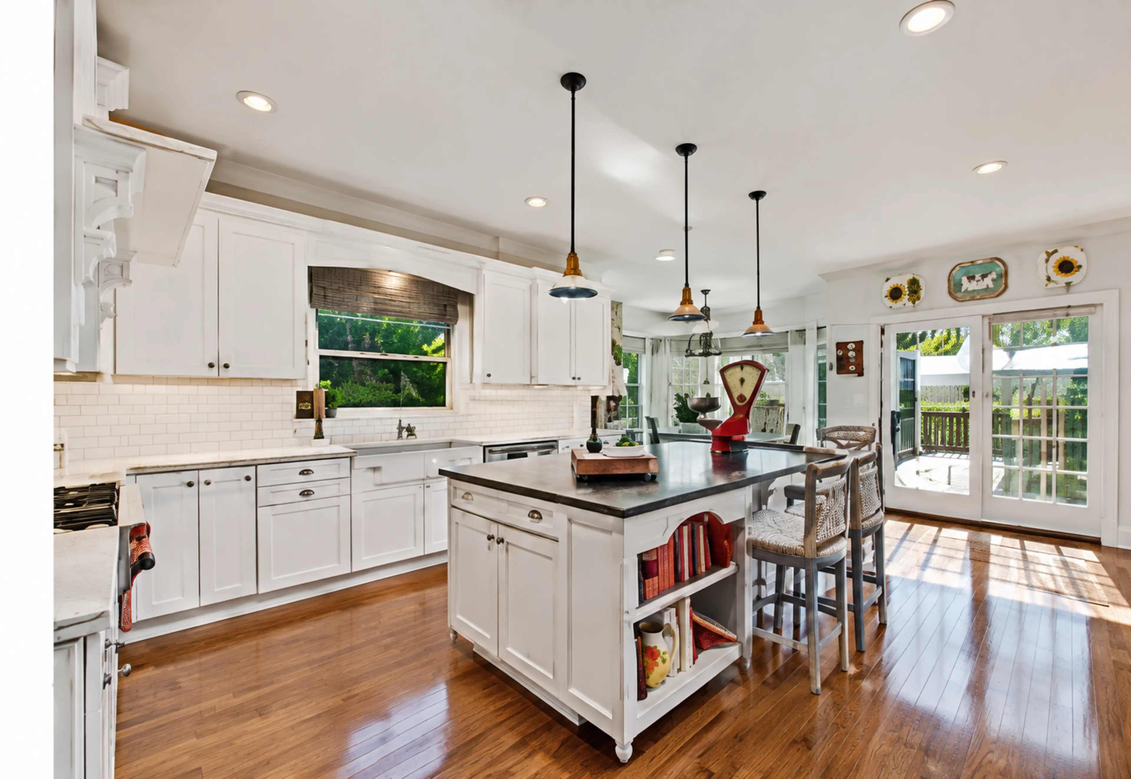 White residential kitchen with pendant lighting and a large central island